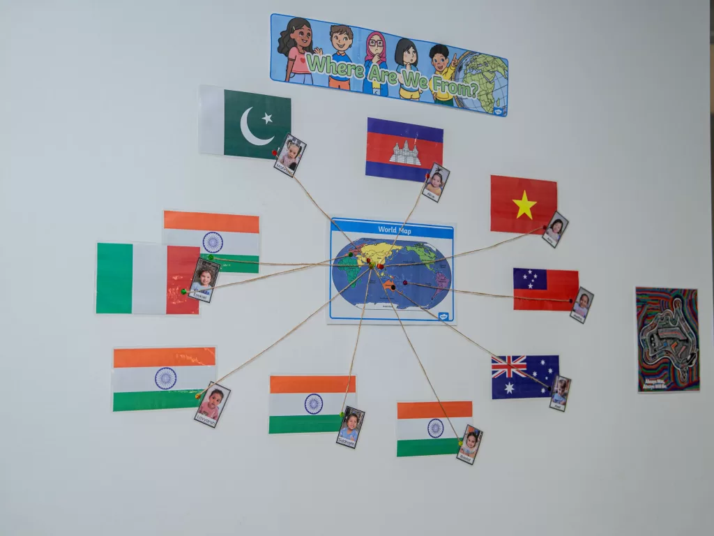 Kinderworld Early Learning Centre multicultural classroom display showing children's countries of origin with flags, photos, and world map